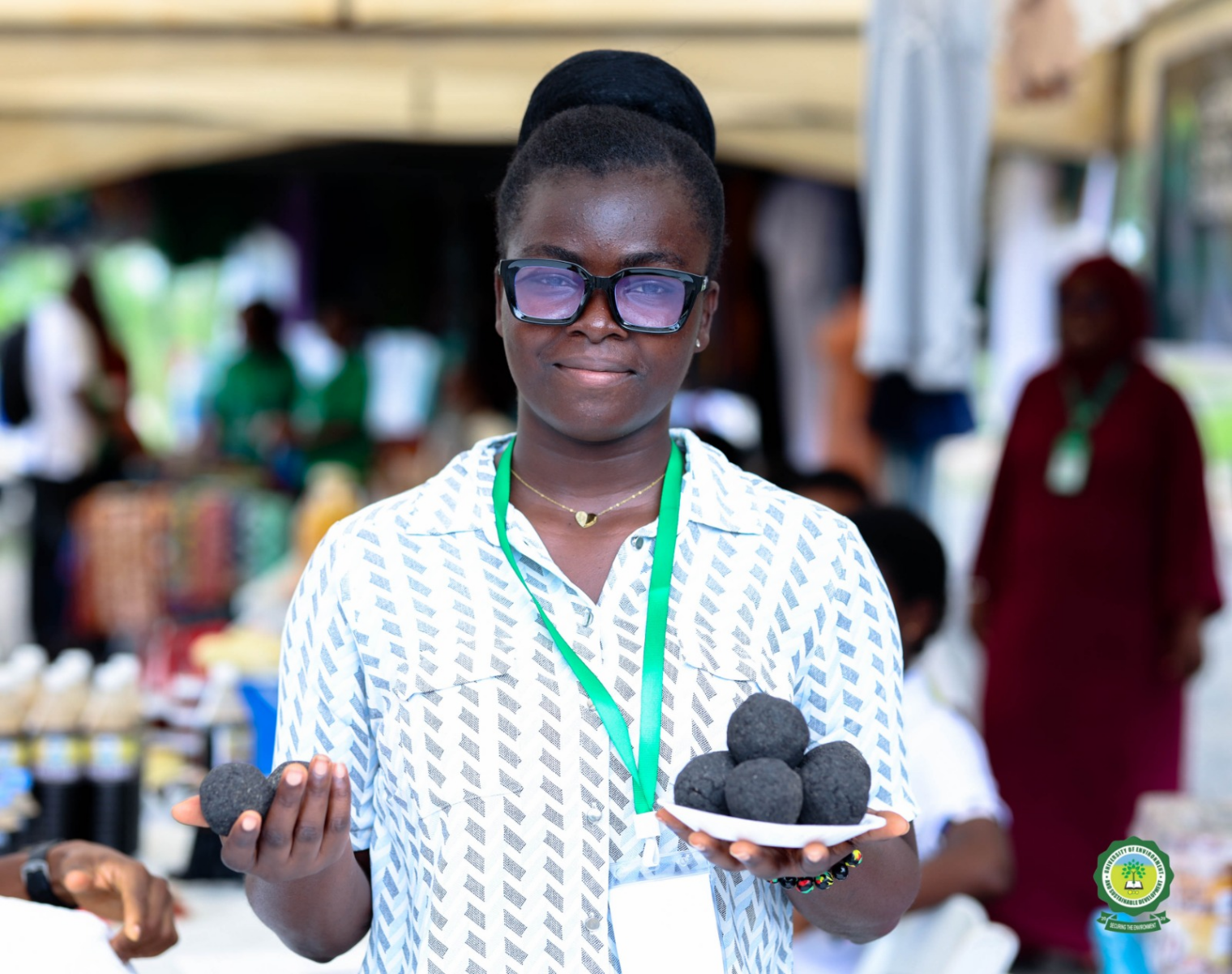 Matilda Gadasu showcases charcoal briquettes produced from agricultural waste.