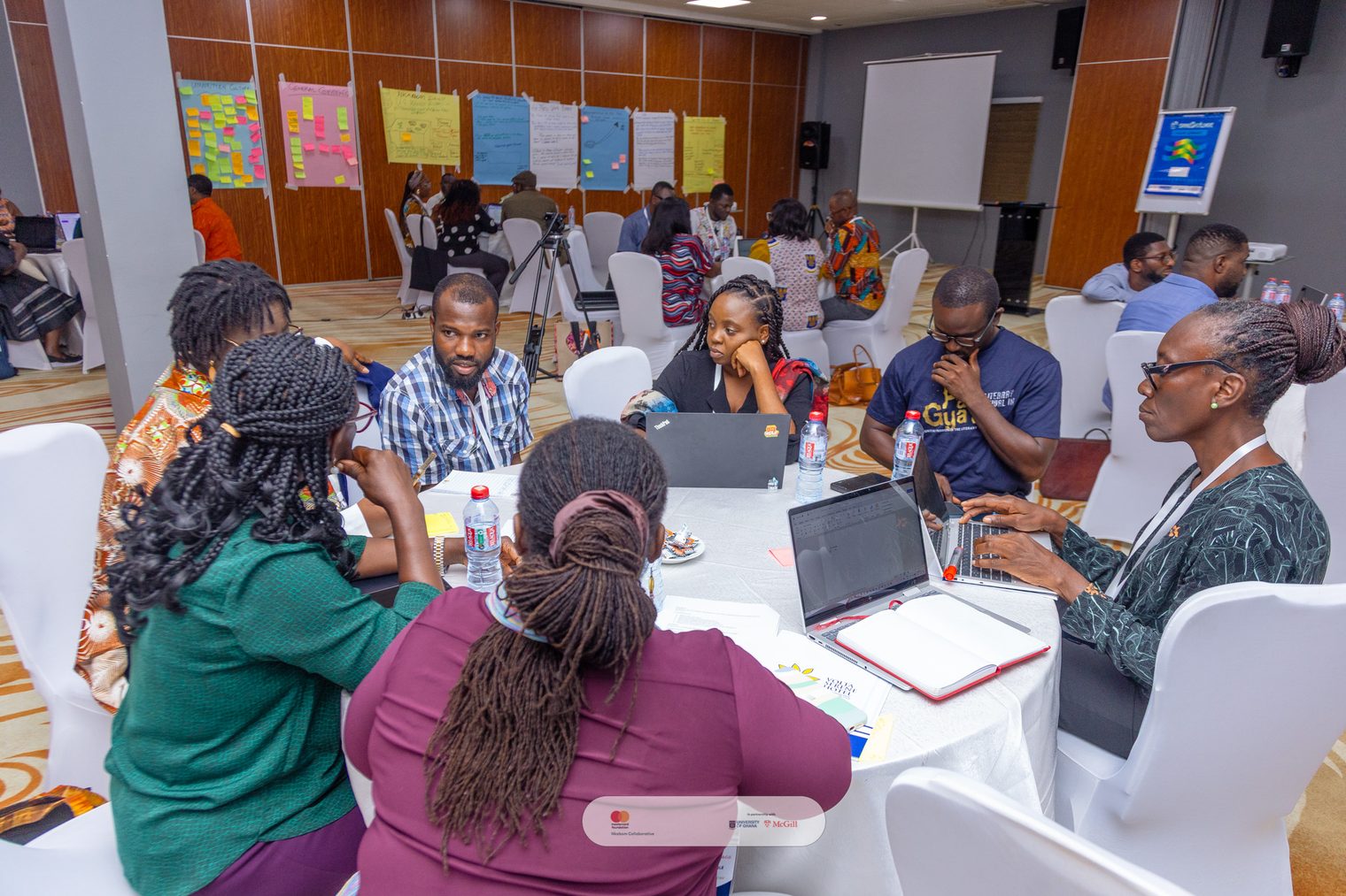 students working and collaborating around a table at the university of Ghana.